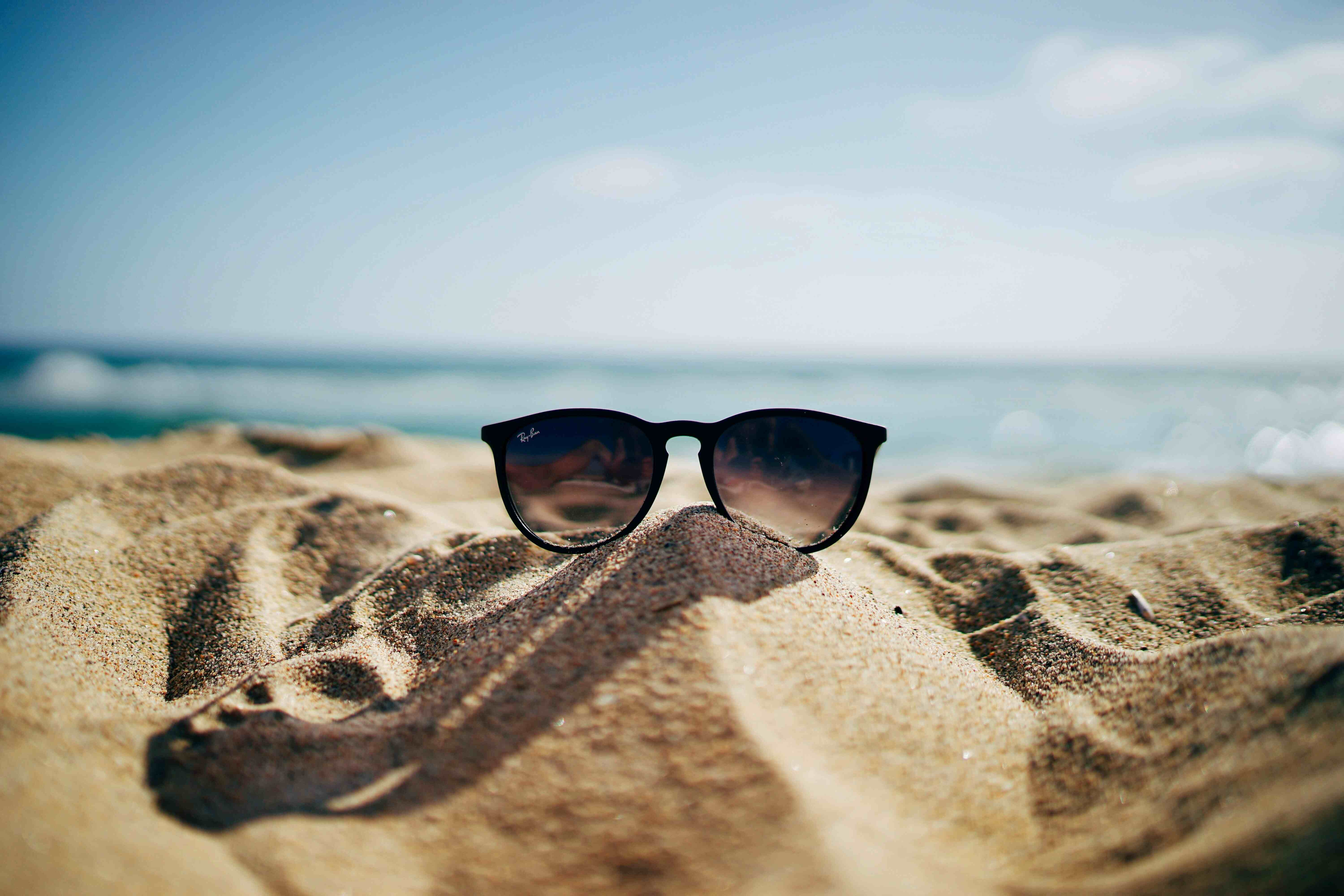 Image of sunglasses on the sand