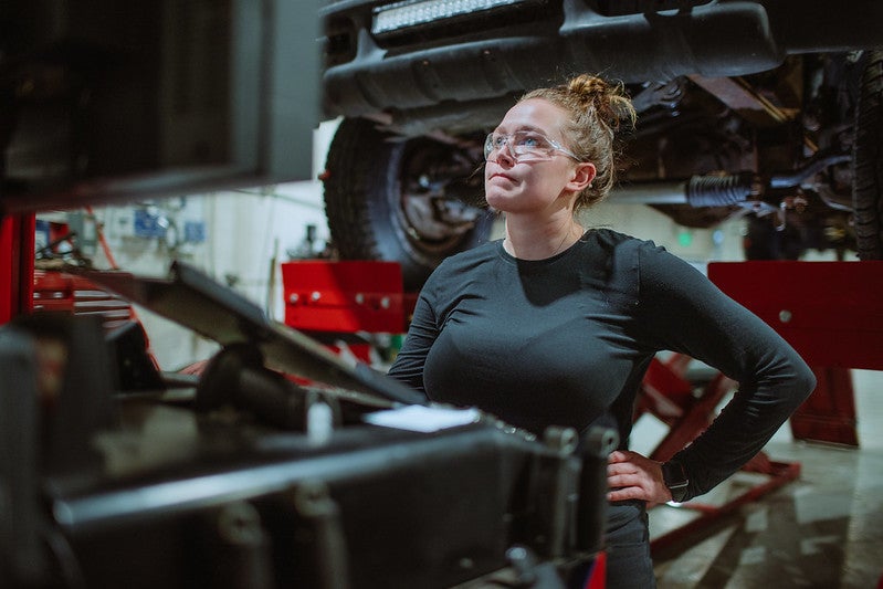 Woman fixing cars