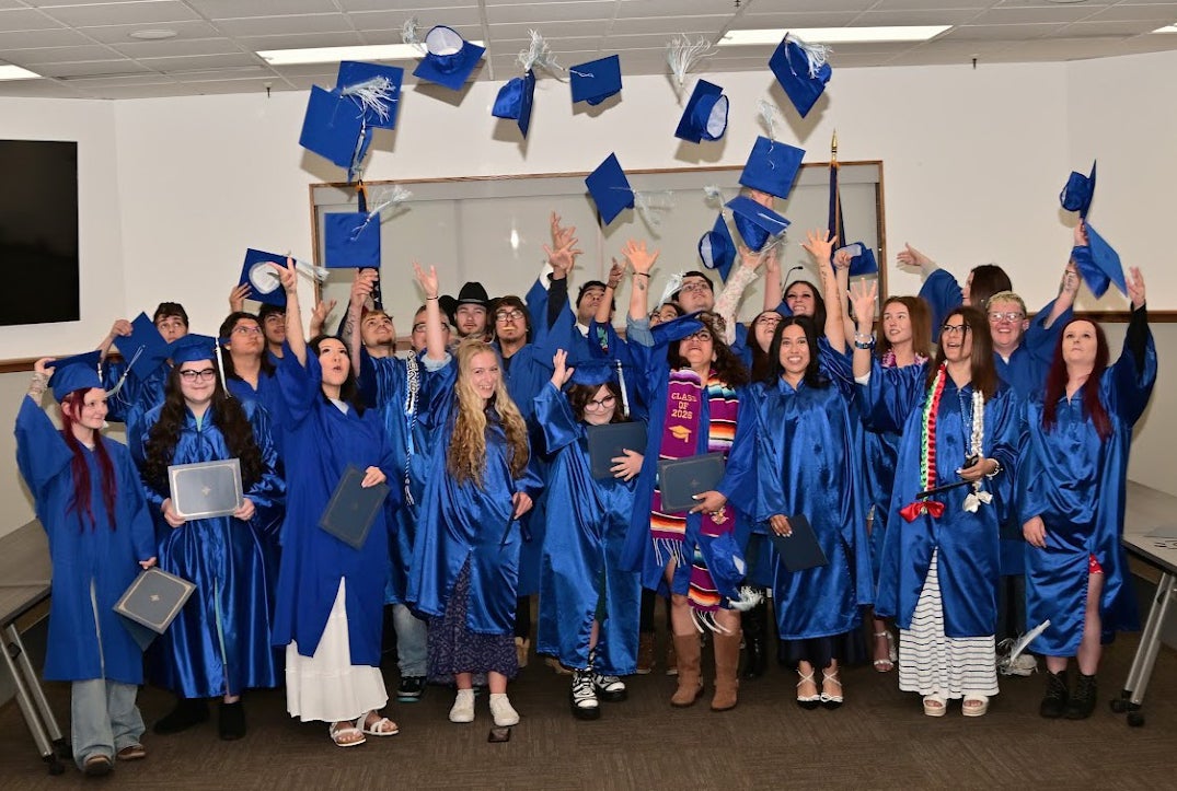 Graduated class throwing their caps