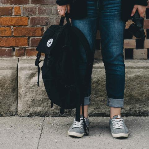 Student holding a backpack