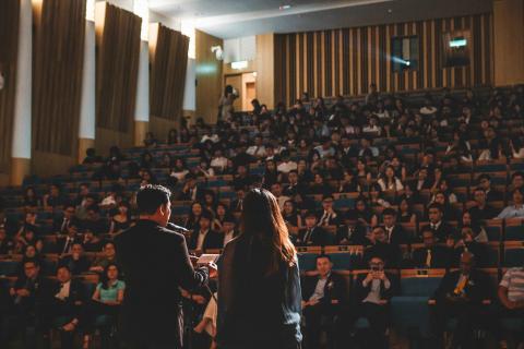 Man speaking in front of crowd