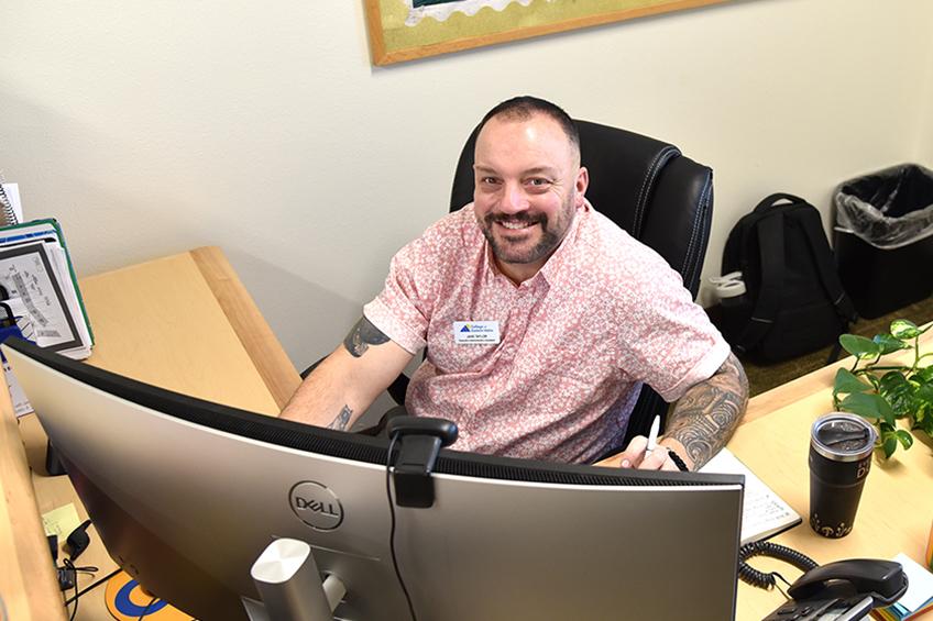 CEI employee at his desk
