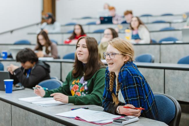 Smiling students in a lecture hall