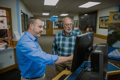 Photo of CEI staff looking at a computer monitor